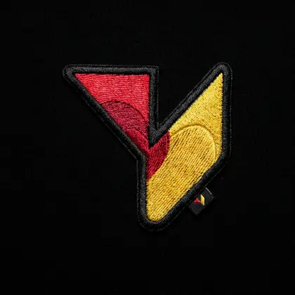 The Vmotif mark stitched as a satin embroidery patch